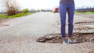 Potholes, Cracks & Curves: Who’s Liable When Bad Roads Cause Wrecks?